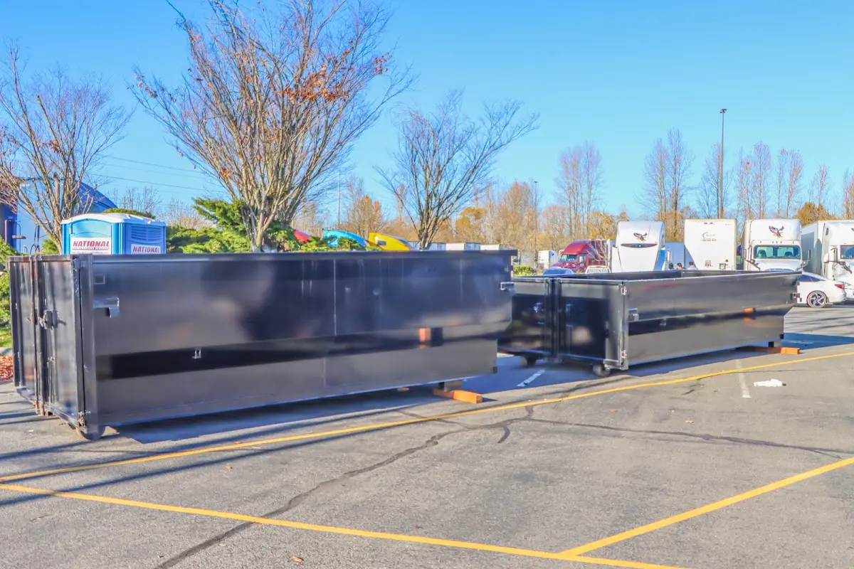 Professional dumpster rental service with roll-off container on residential driveway in Wilmington